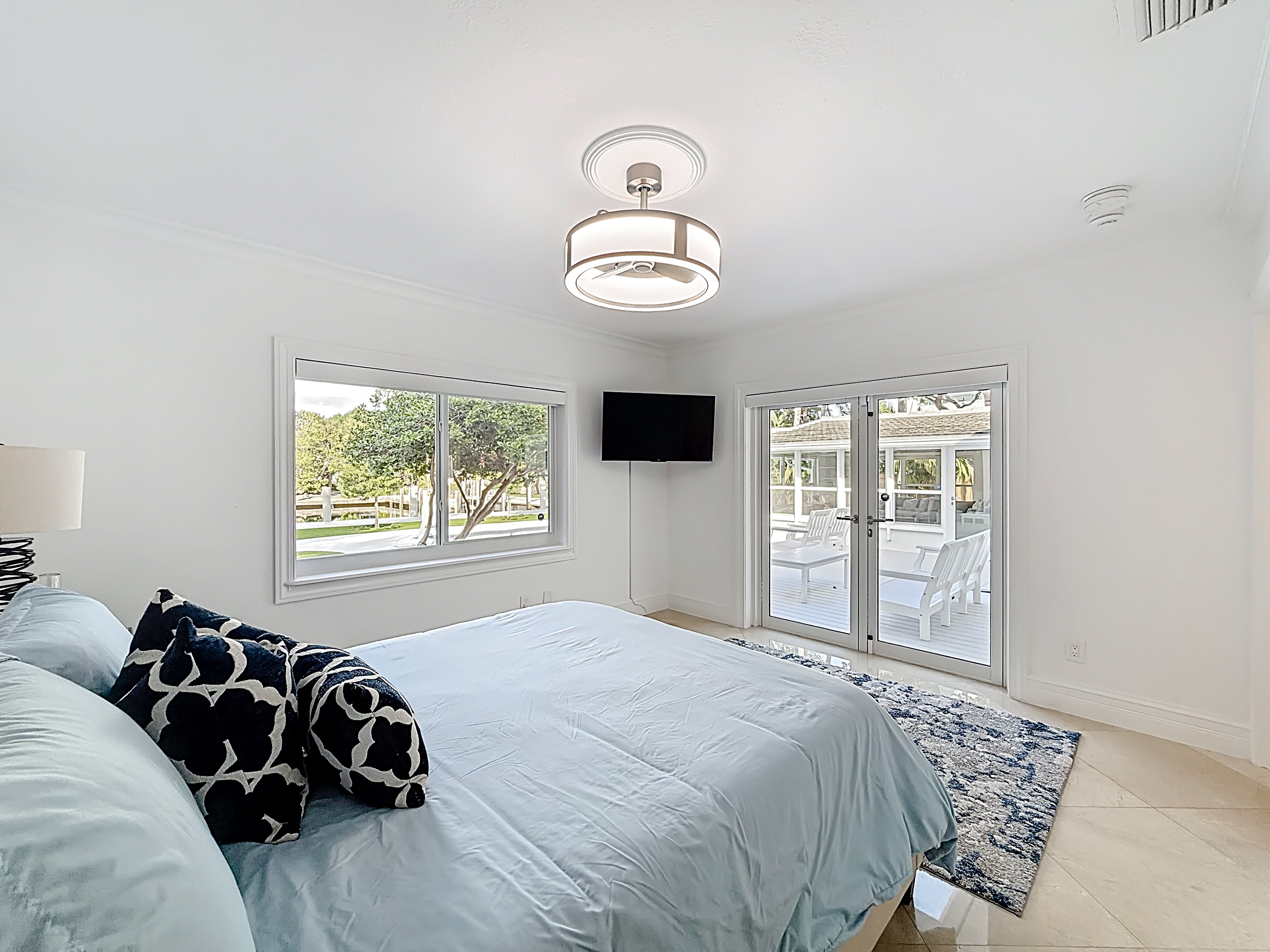 The second bedroom has a great view of the water and pool  with lots of light. Like the rest of the house, the remote blinds are great. 