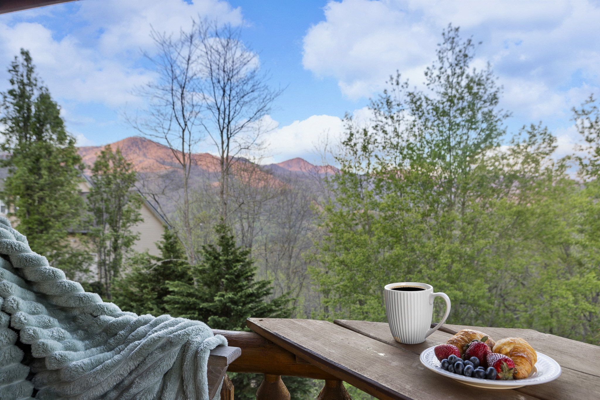 Balcony Delight: Sip coffee with breathtaking mountain views and fresh pastries at sunrise!