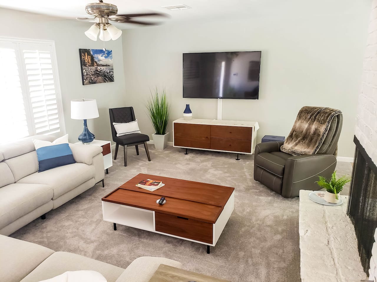 Large comfortable living room. Recliner chair and couch. Large 65 inch Smart TV.