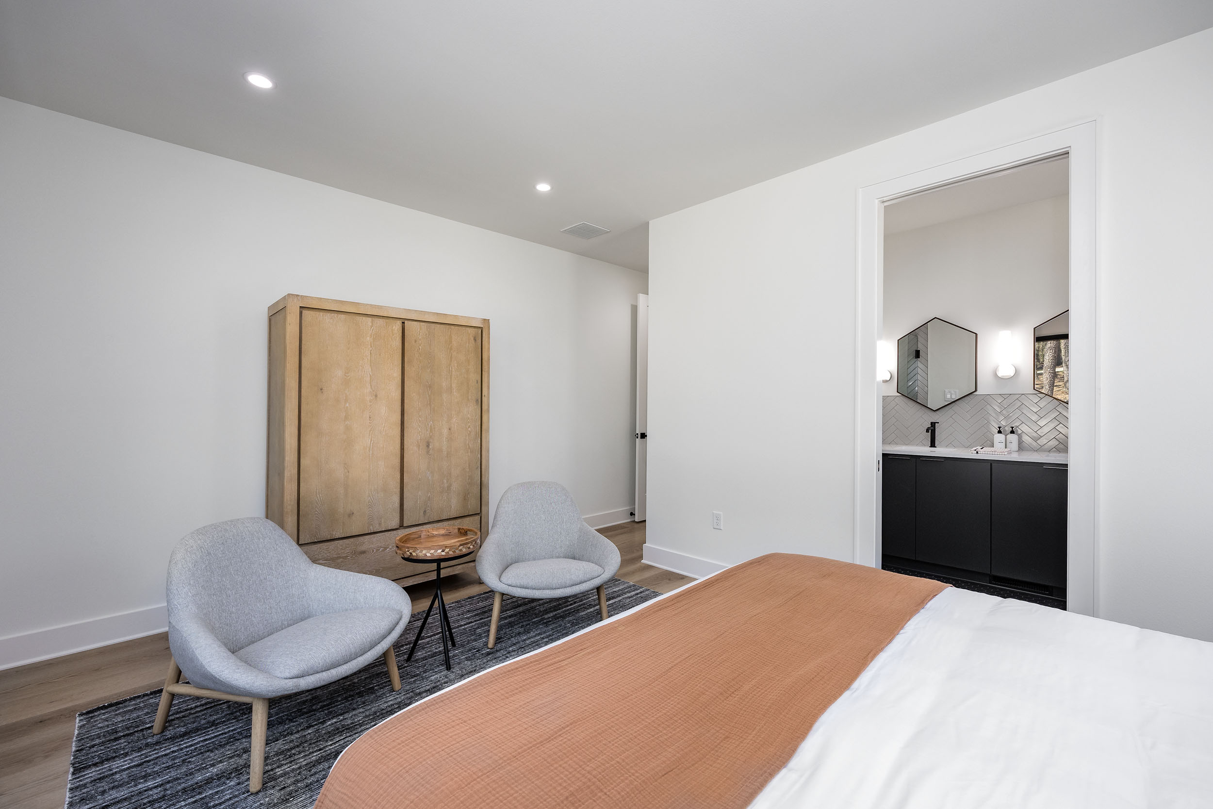 A king bedroom with woodland views and artistic flair, designed for rest, warmth, and style.