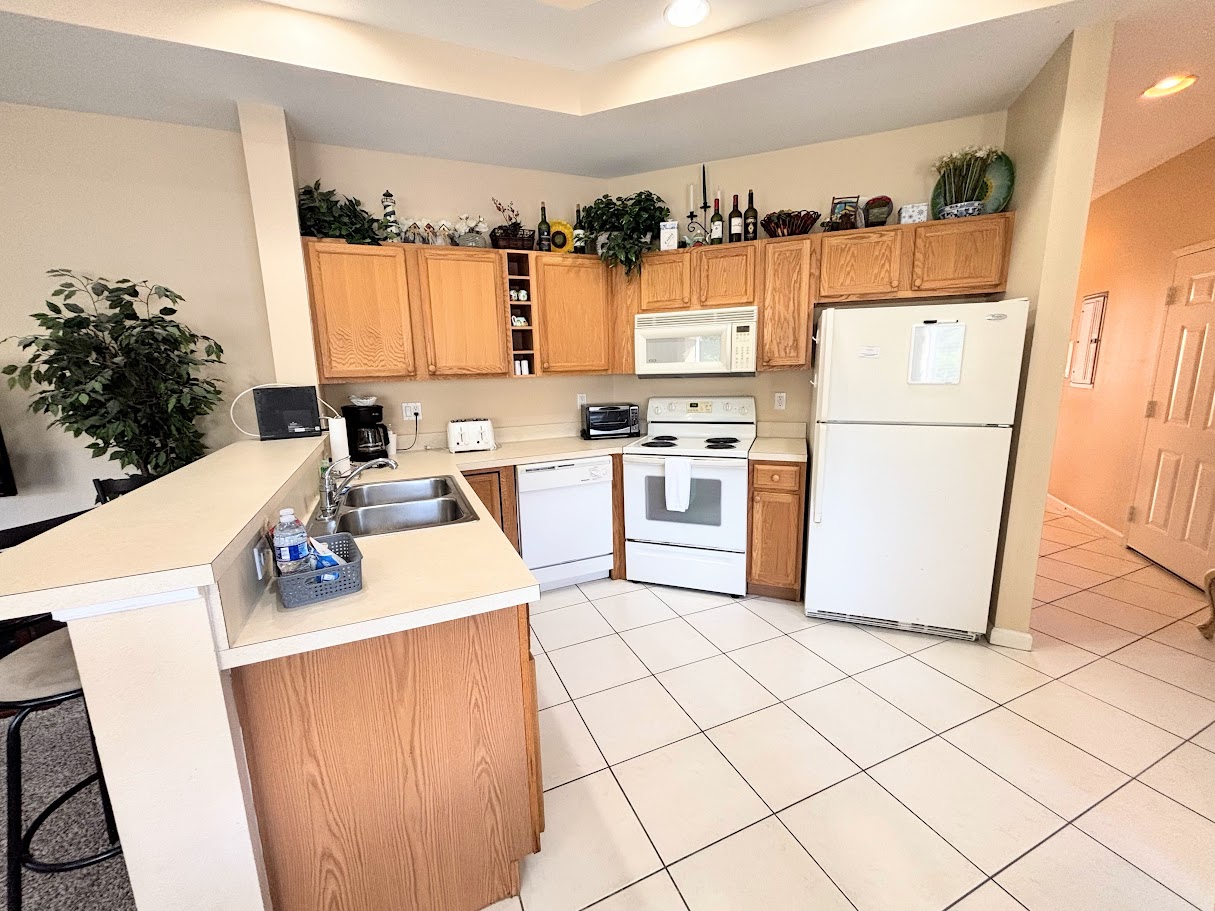 Spacious kitchen with plenty of cabinet storage, full-size appliances, a breakfast bar, and an open layout that flows into the dining and living areas.