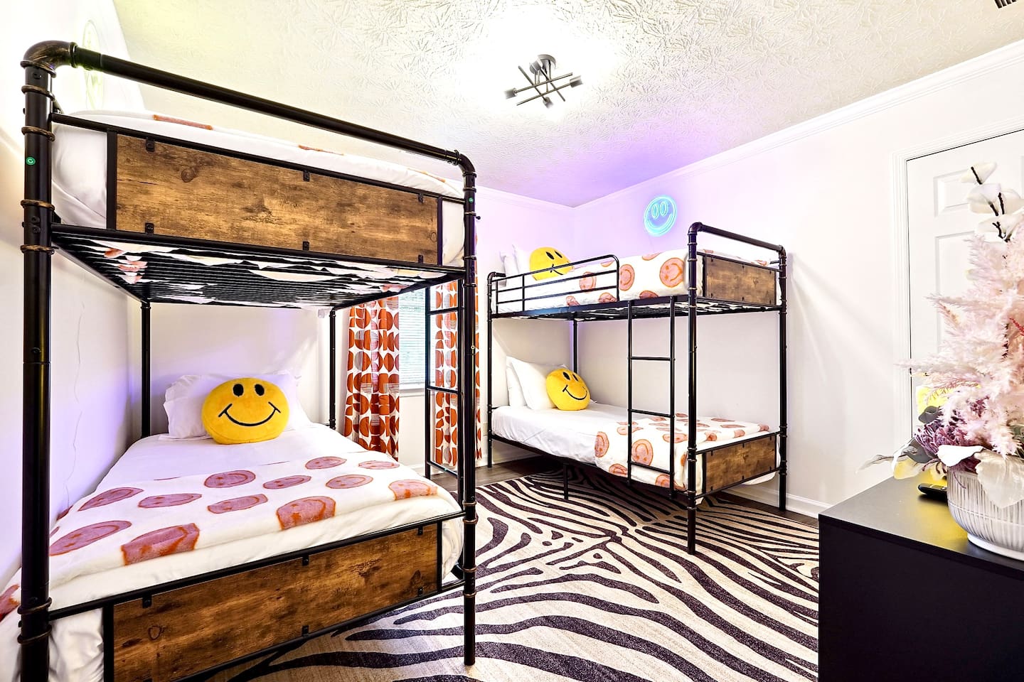 Bedroom 5 is located upstairs, features double bunk beds and a TV. This room does not have a private en-suite bathroom but has access to a shared bathroom.