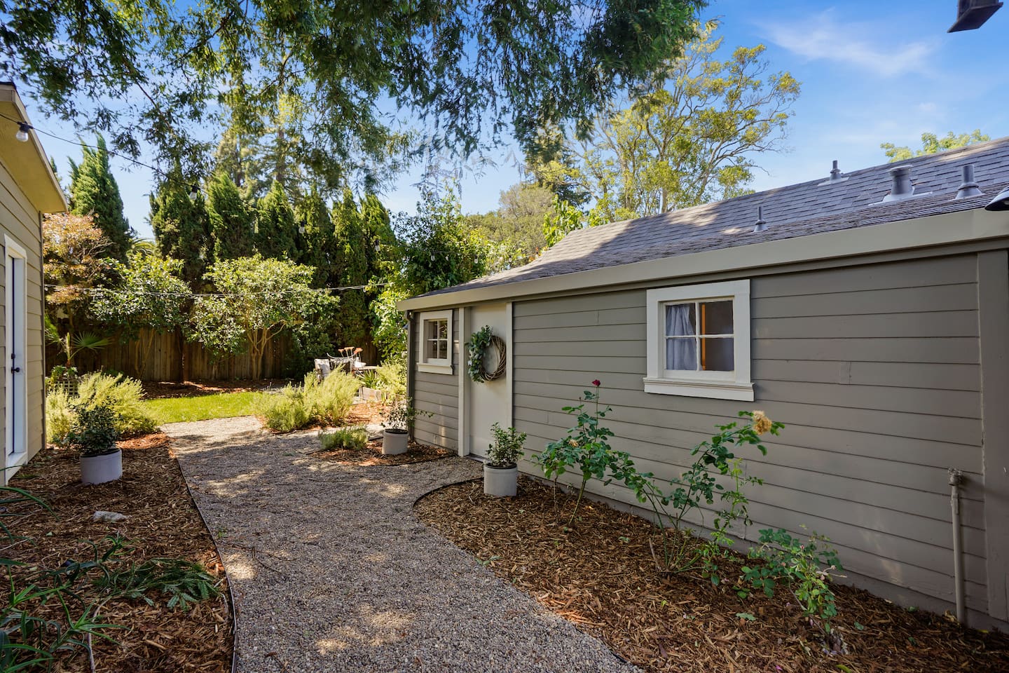 Charming private studio entrance with stylish outdoor seating, peaceful surroundings, and a welcoming Napa retreat feel.