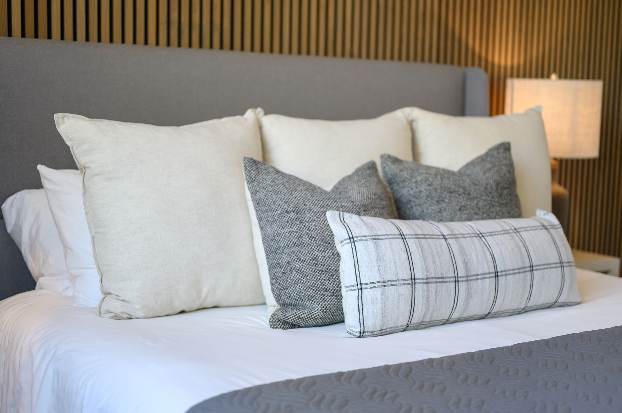 King Suite 2 - Large and spacious suite with teak wood paneling, designer finishes, smart TV, premium king mattress, and luxury bedding. Includes stunning views of the hardwood forest. 