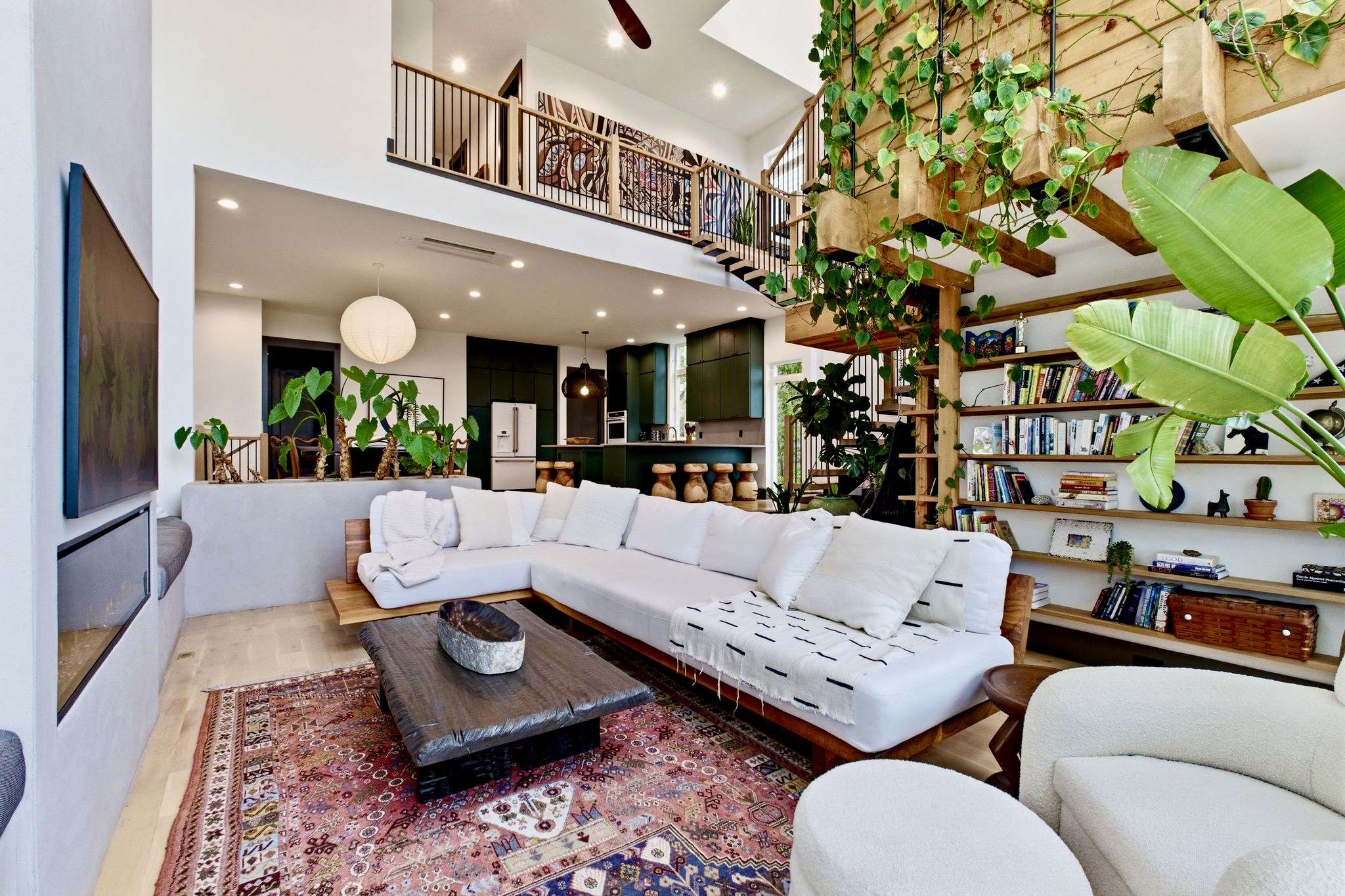 Eclectic living room w/ built-in bookshelves, patterned rug & a laid-back, creative energy.
