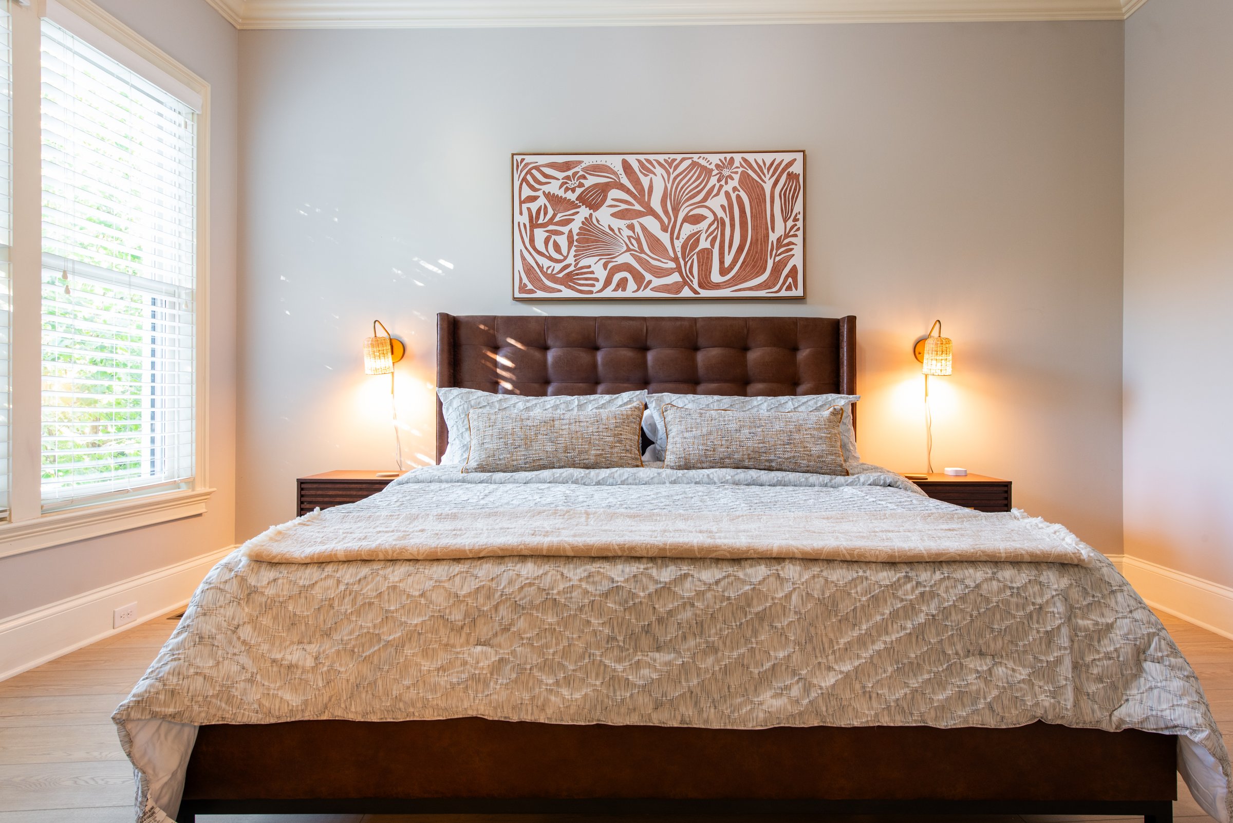 Comfortable king bed with bedside lighting and closet storage.