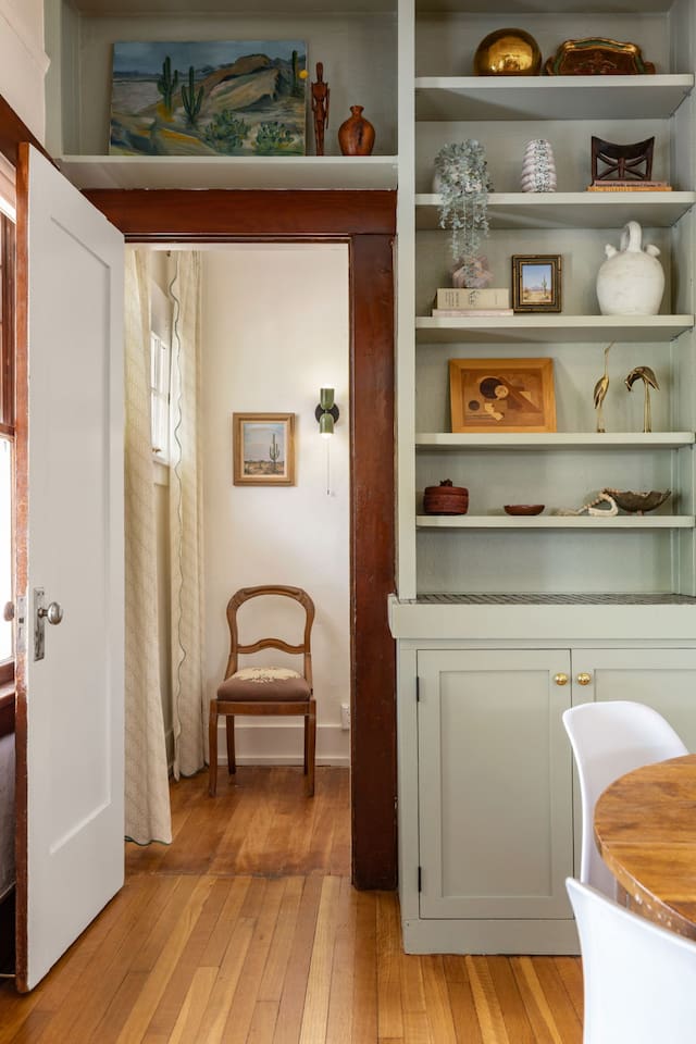 dining room shelves with door to 3rd bedroom nook.