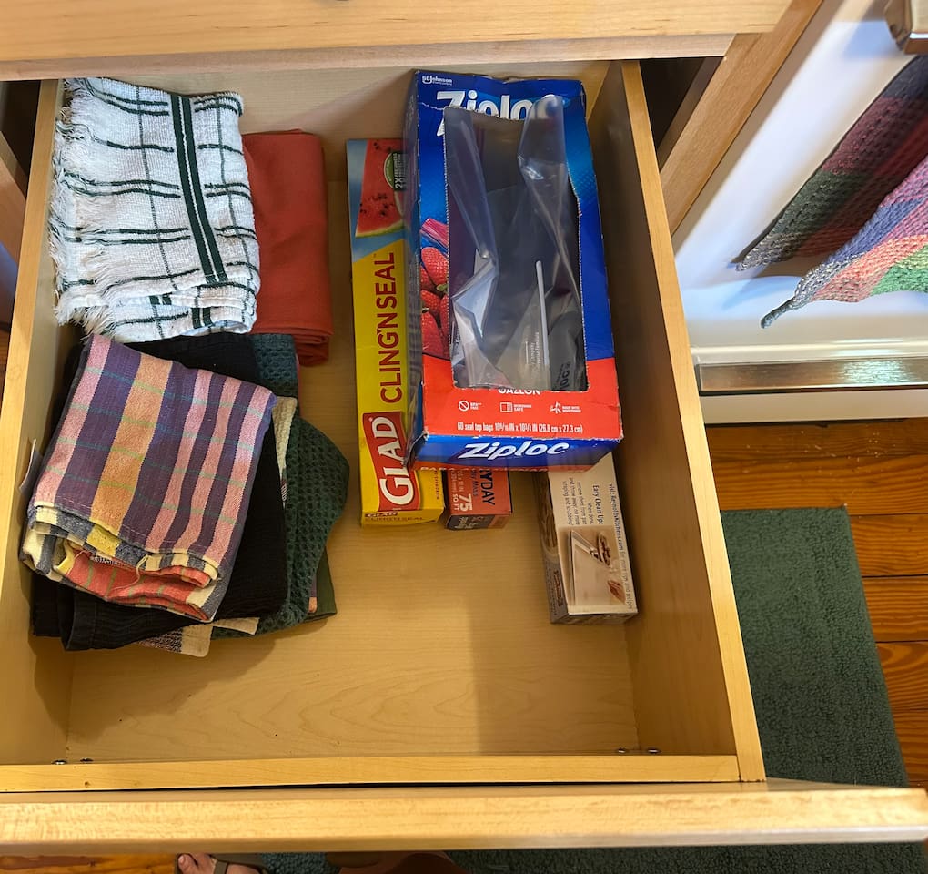 Fully stocked kitchen with everything you need—cookware, utensils, dishware, and coffee maker. Compact yet efficient, ready for cooking meals or enjoying takeout with ease.