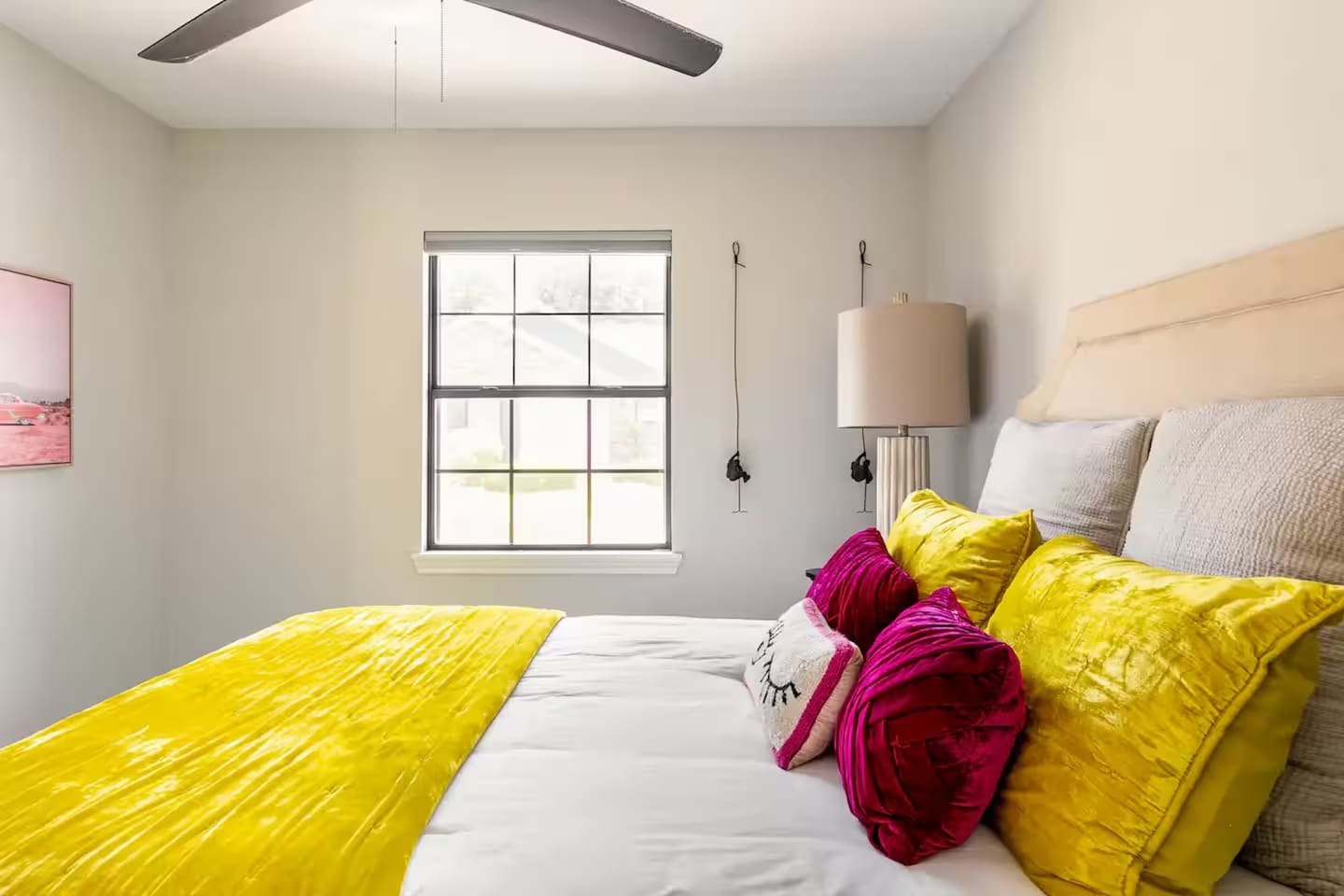 Bedroom with queen bed and bold yellow bedding.