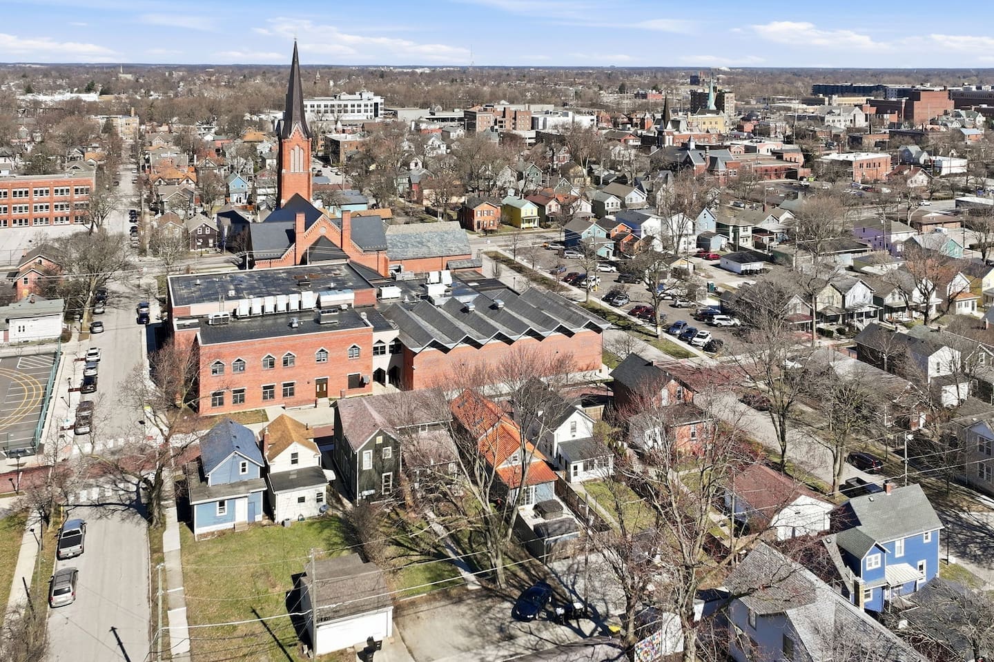 Elevated perspective showcasing the surrounding area with nearby architecture and community feel