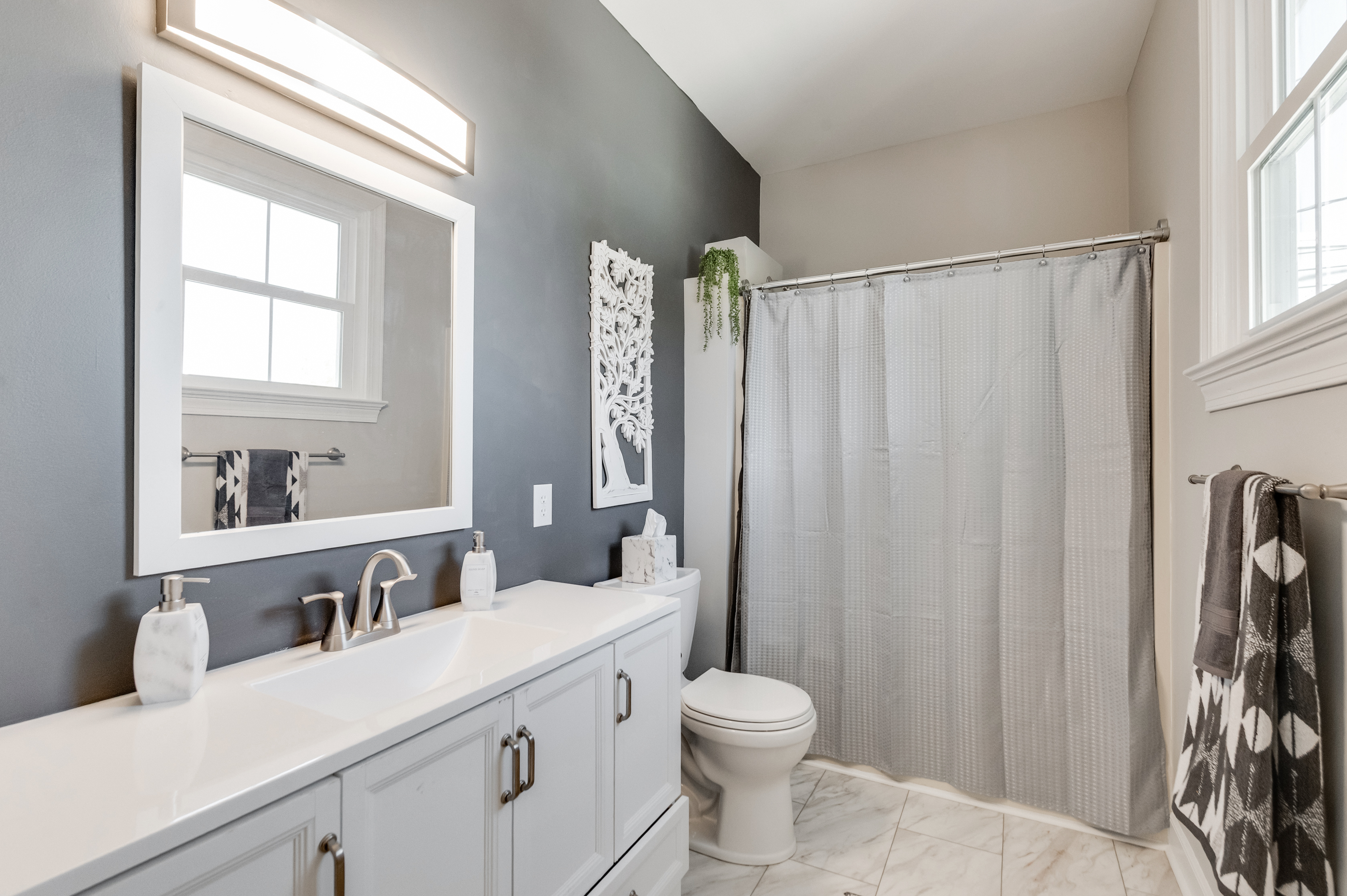 Bathroom 1 (Hallway): Modern finishes and bright natural light create a refreshing space for relaxation!