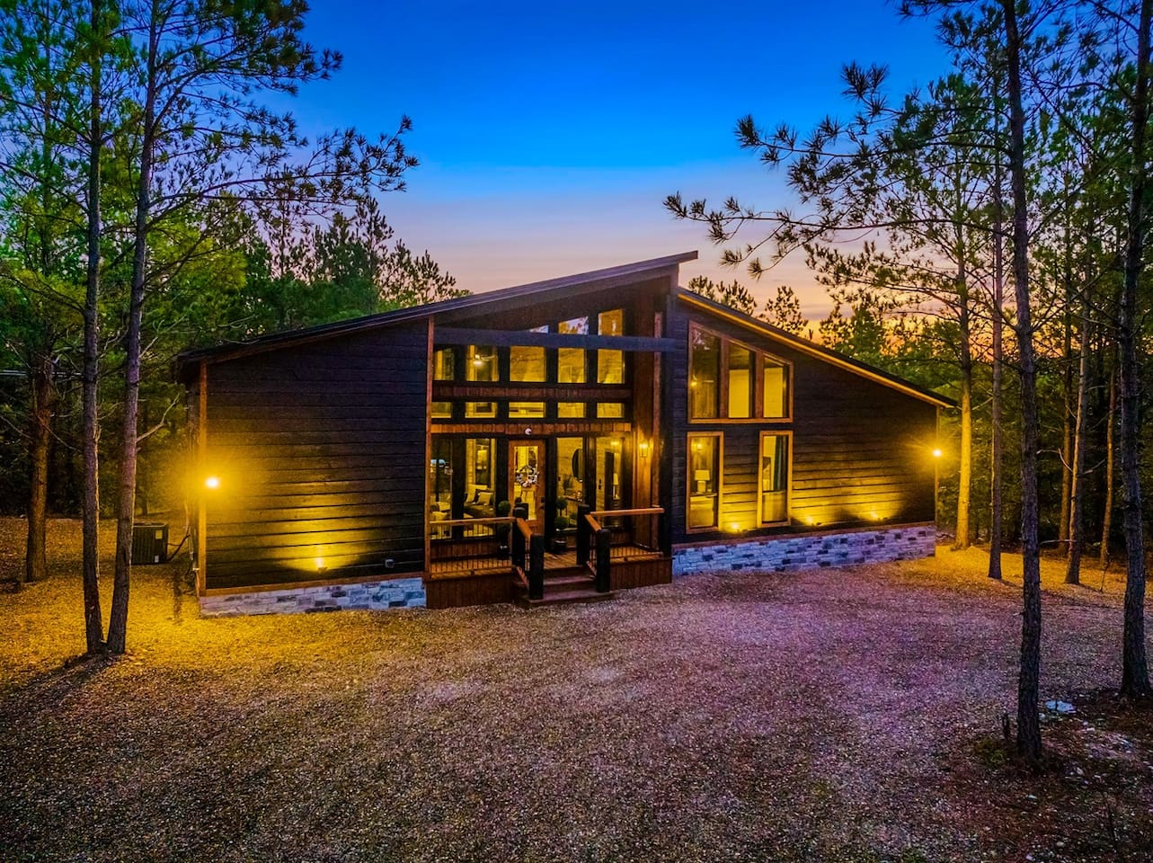 Front View of the Cabin: Experience rustic charm surrounded by nature at sunset!