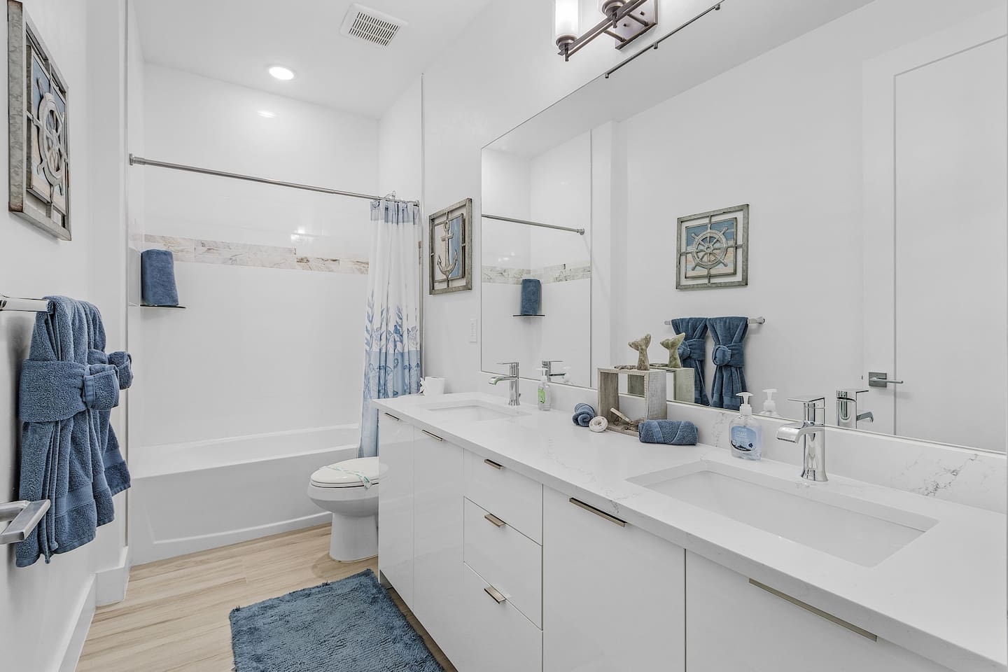 2nd Guest bathroom equipped with a tub and shower combo and dual sinks, offering both functionality and comfort!