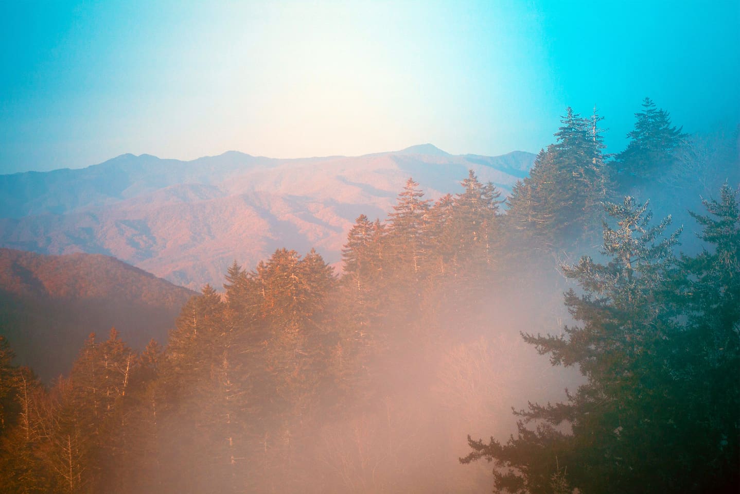 Sunlight floods the valleys