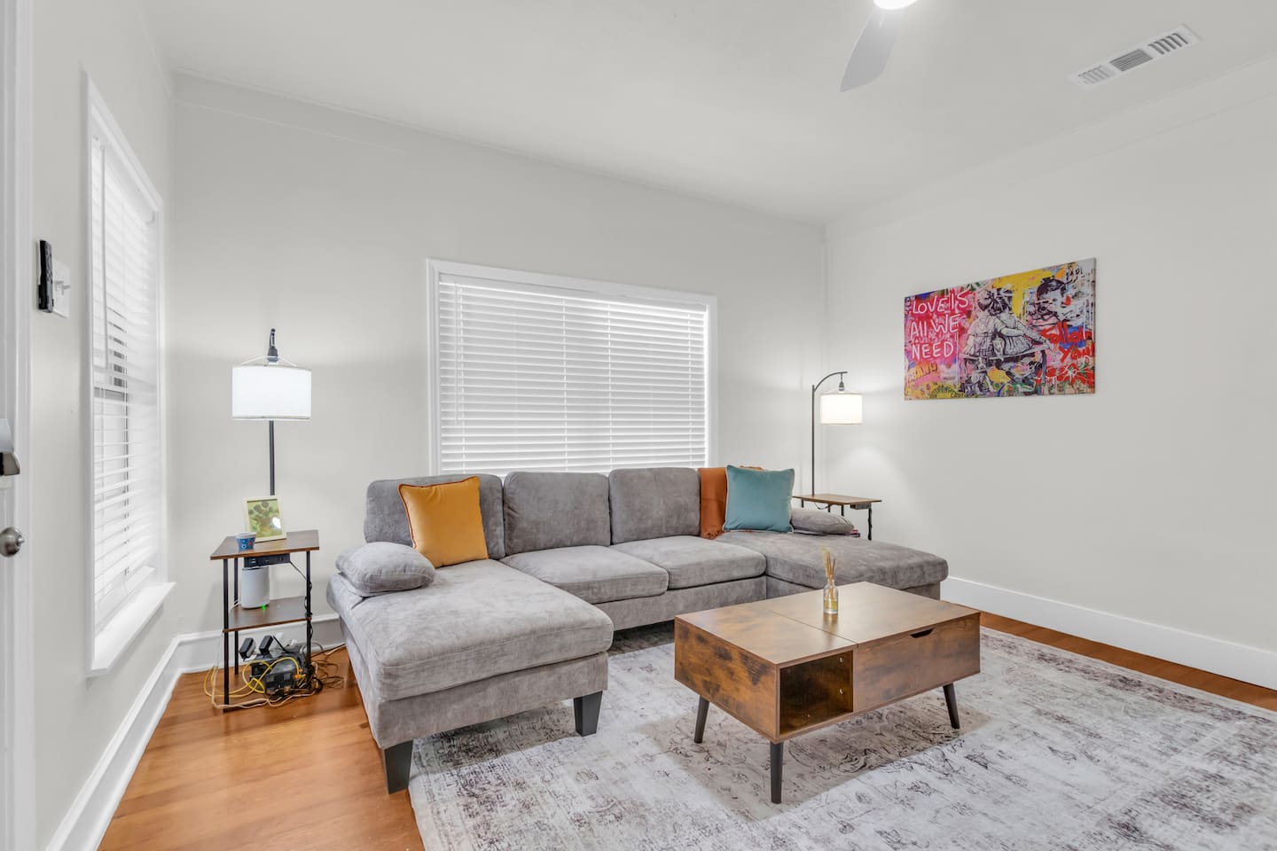 Bright living room with sectional sofa and natural light.
