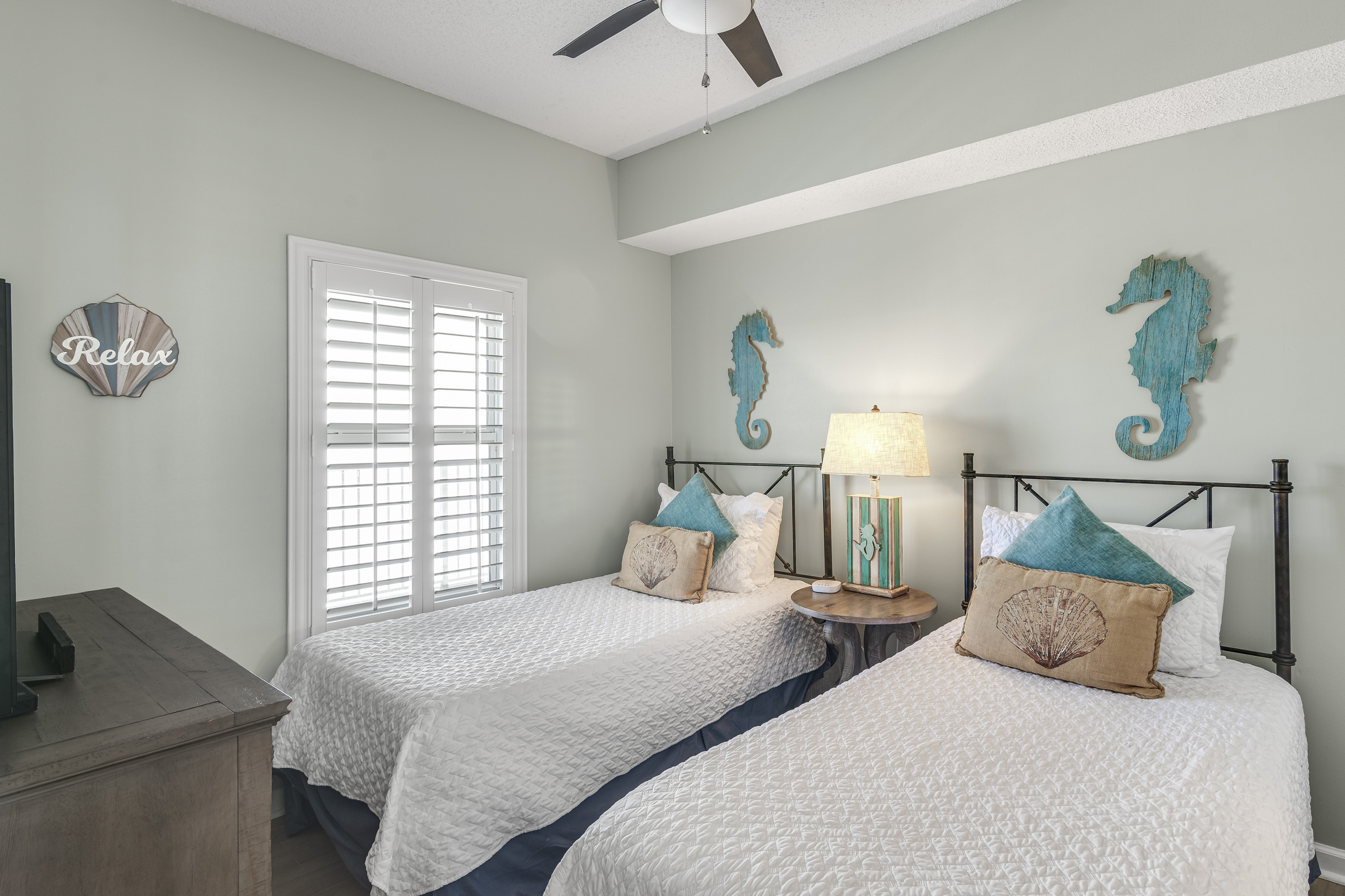 Guest Bedroom has two Twin Beds, TV, attached closet, and attached bathroom with shower/tub combo
