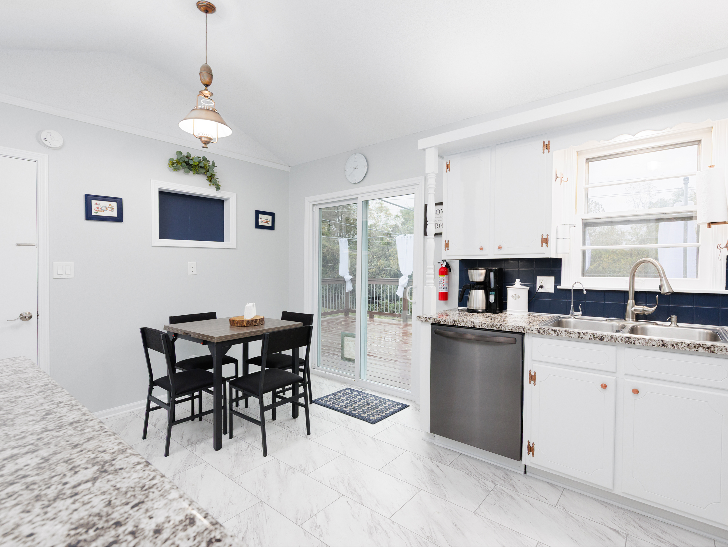Eat-in kitchen dining area with expandable table seating up to six guests comfortably. Layout designed for easy meals, conversation, and entertaining.
