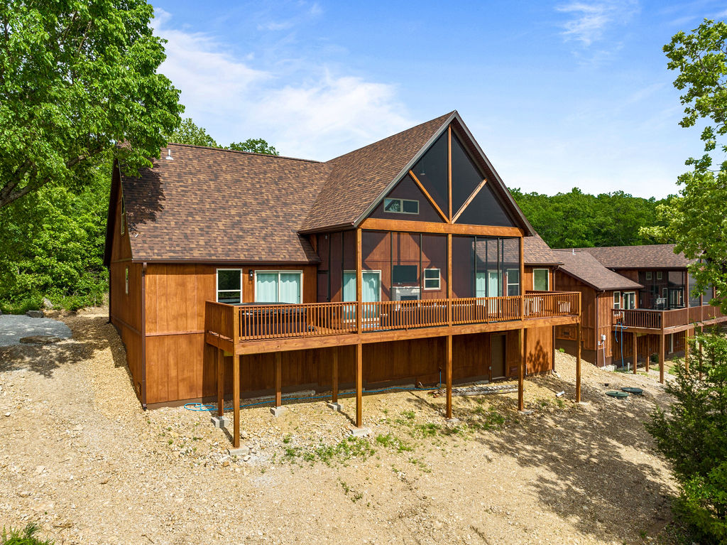Back elevation showing hot tub and screened porch. We also have the 2 neighboring 4 bedroom properties available if you need more space.