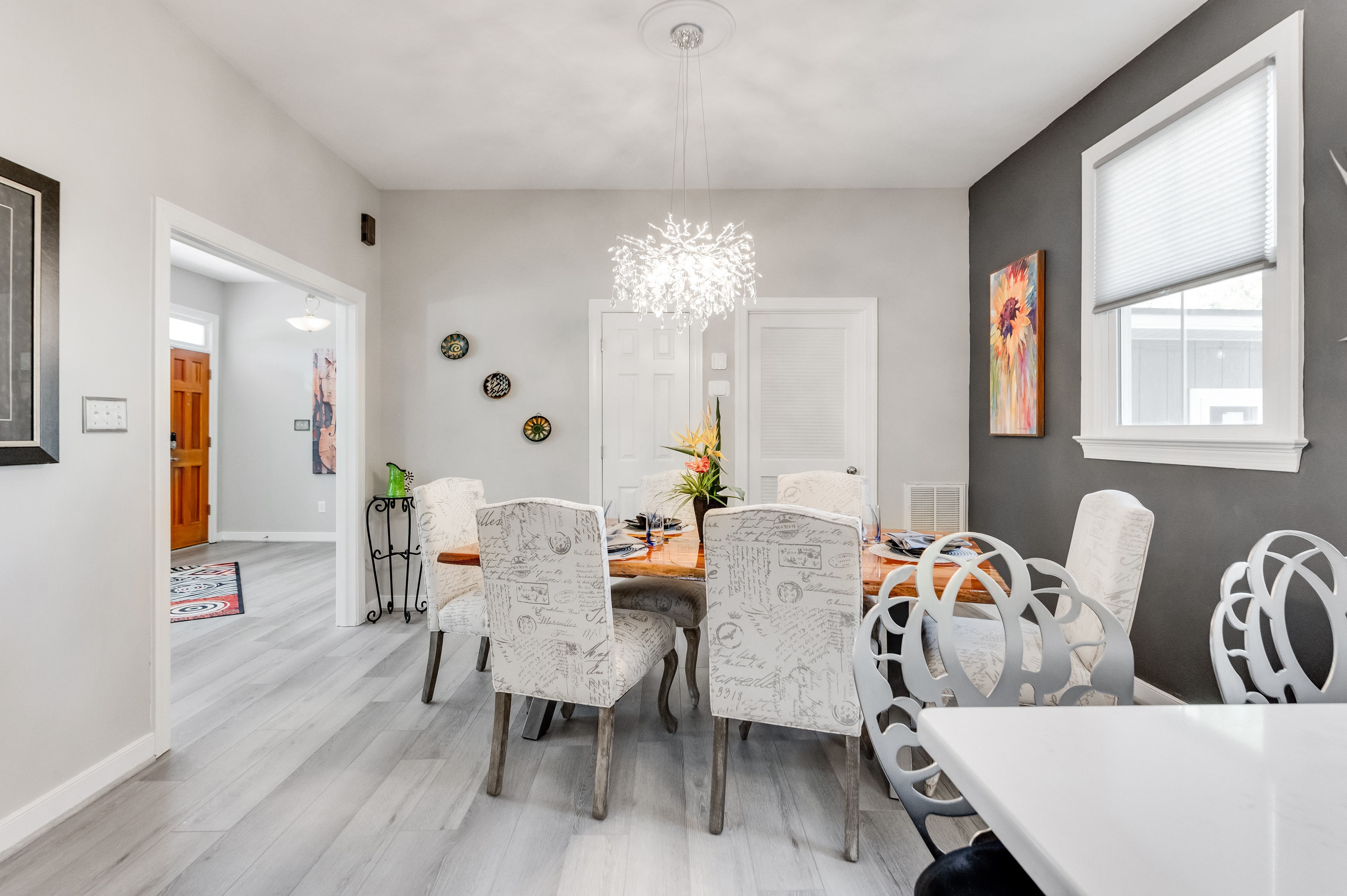 Dining Room: Gather around a chic table, illuminated by a stunning chandelier and vibrant decor!