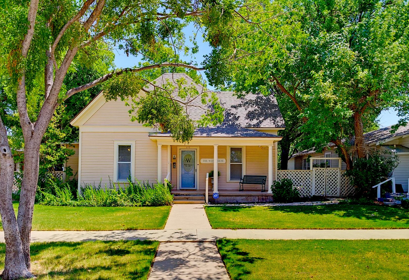 The Webb House - Historic 1905 Craftsman home in Old Town Abilene, TX — walkable to Abilene Convention Center. A charming front porch, mature shade trees, manicured lawn & classic curb appeal. A deep covered front porch with bench invites relaxation. 