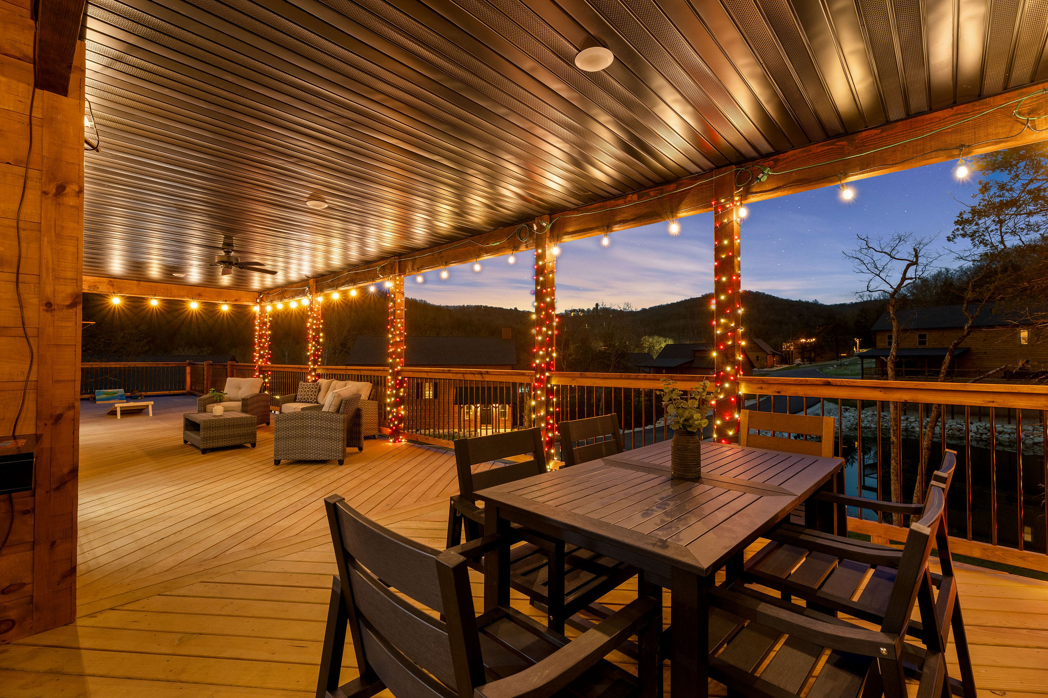 Covered deck with outdoor dining, perfect for relaxed meals.