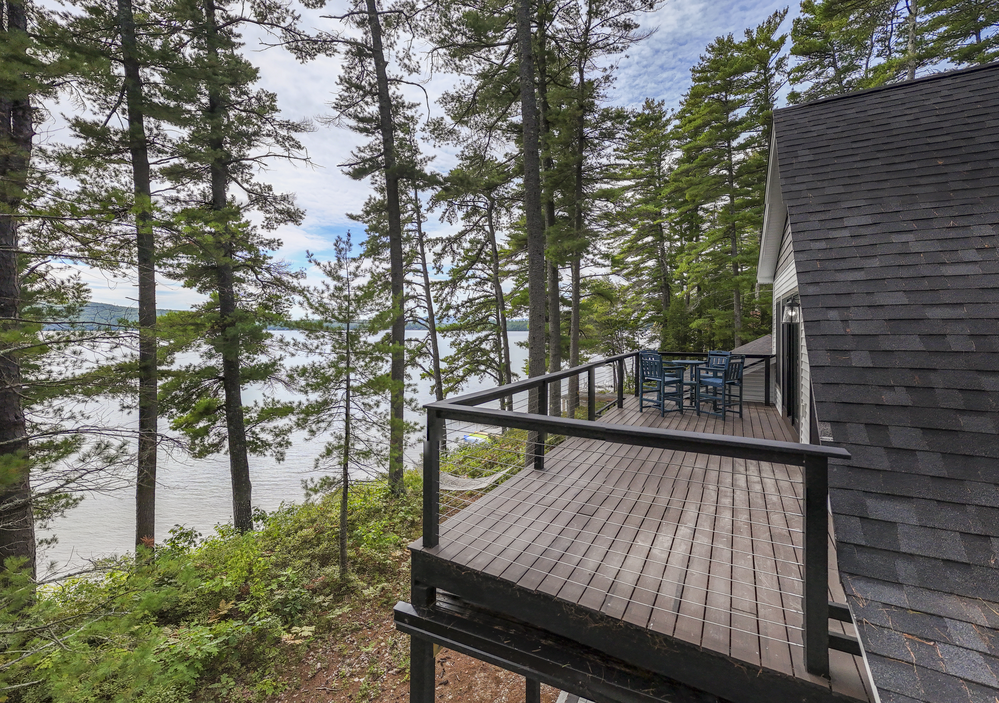 Step onto the balcony for views of Great East Lake through the trees, with the hammock waiting just below for a little lakeside downtime.
