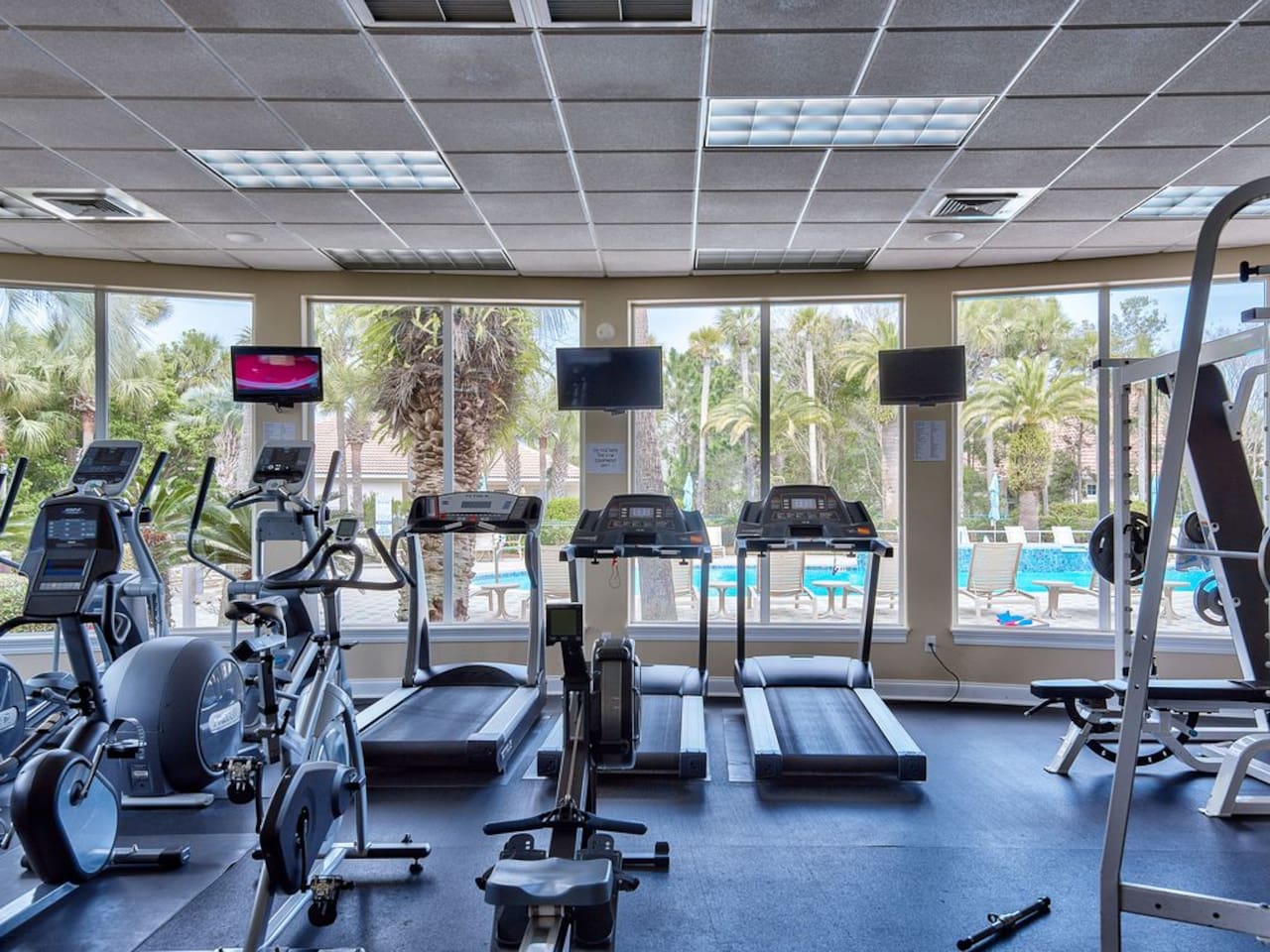 Clubhouse gym overlooking the pool, fully equipped