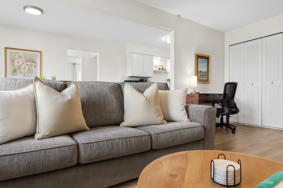 Bright and modern 1BR with stylish décor, comfy sofa seating, and a dedicated workspace.
