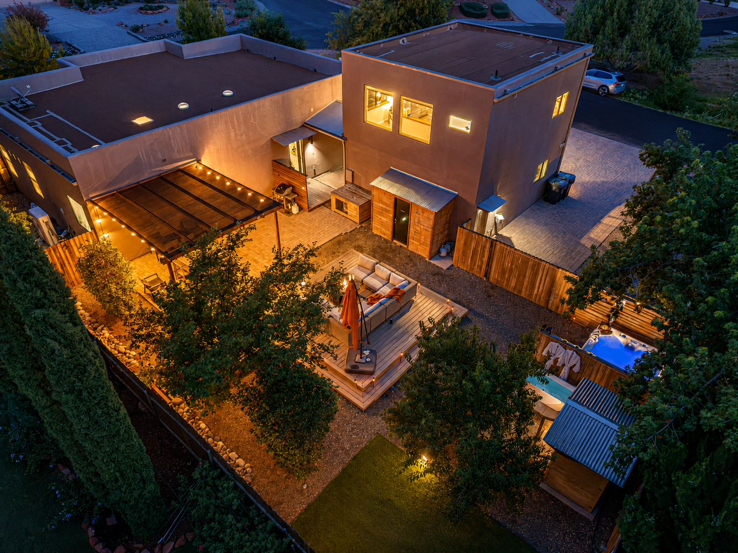 {Property at Dusk} Your private Sedona retreat glows after sunset, with multiple outdoor spaces designed for gathering and relaxing.
