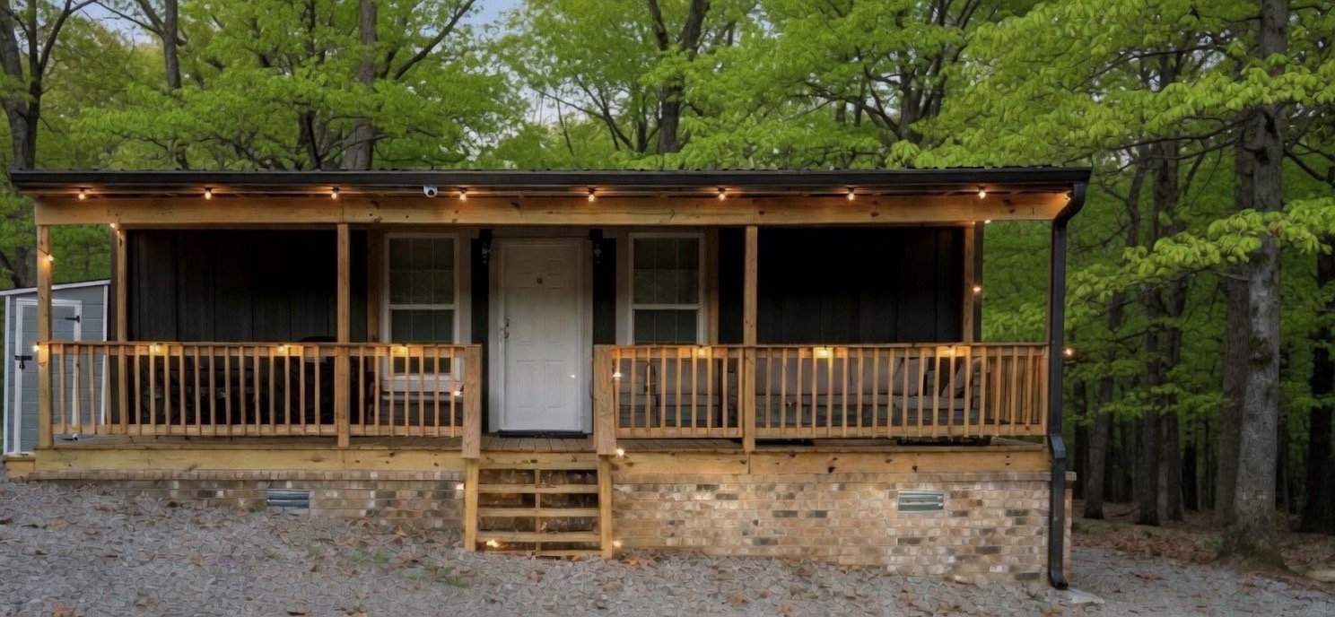 Welcome to TinyWoodsEscape – your cozy cabin in the woods, glowing at dusk