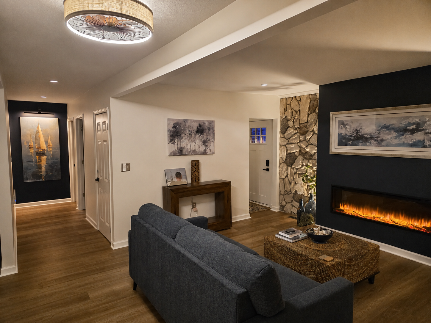 Cozy main-floor living room with a fireplace, stone accent wall and comfortable seating for relaxing after a day at the lake.