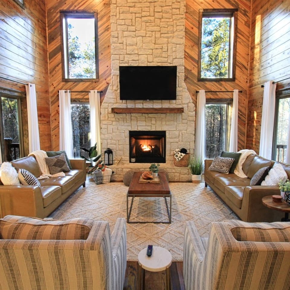 Relax by the indoor fireplace in a cozy living room designed for family comfort.