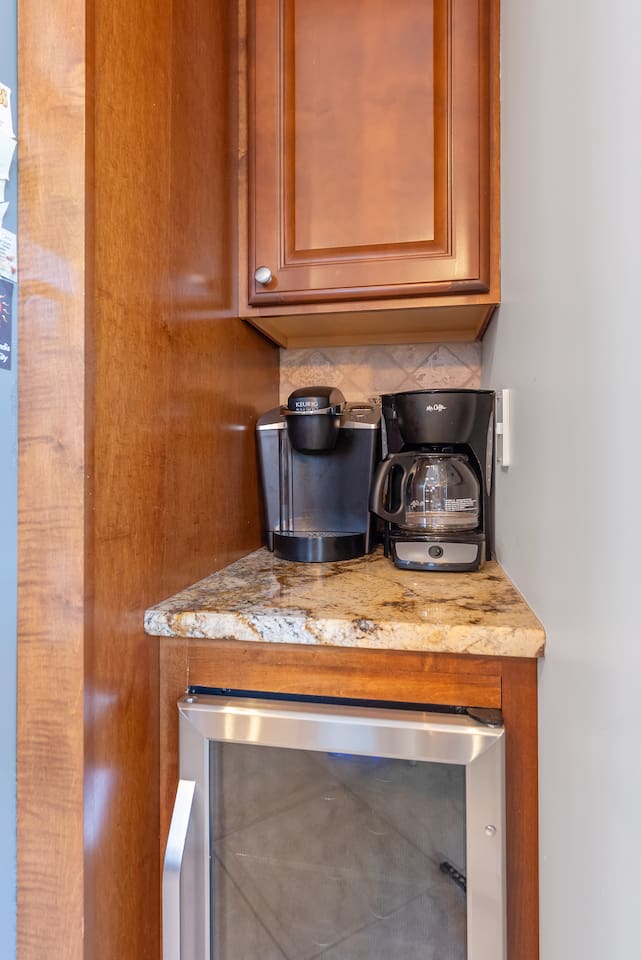 Full kitchen with stainless steel appliances, large island for additional seating, ample prep space and separate beverage refrigerator. Keurig and regular coffee maker. 