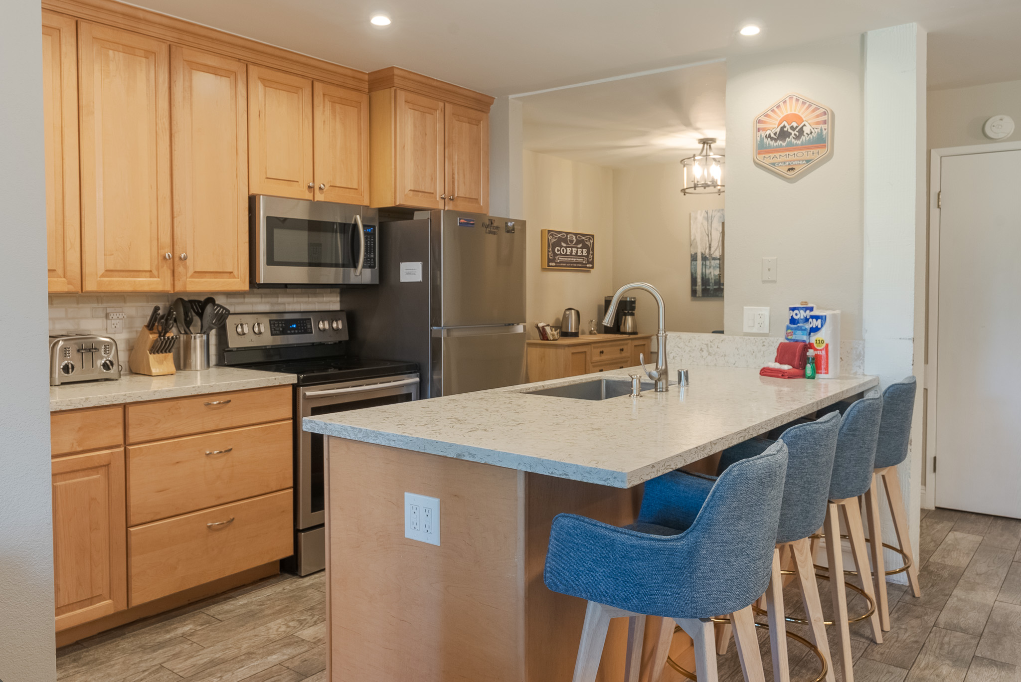 The kitchen is located near the coffee bar (in the background).