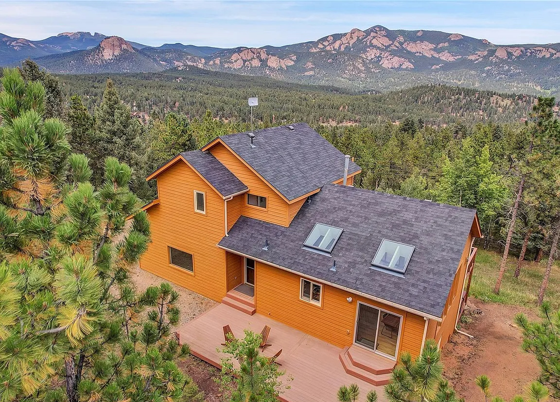 Close-up aerial look at the cabin exterior and private deck area.