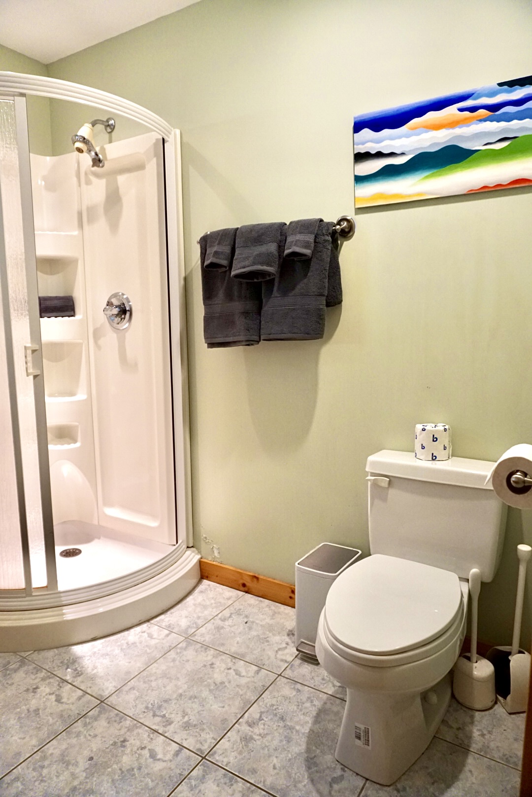 Sleek Bathroom: Enjoy modern design with vibrant art and plush towels for your refreshment ritual!