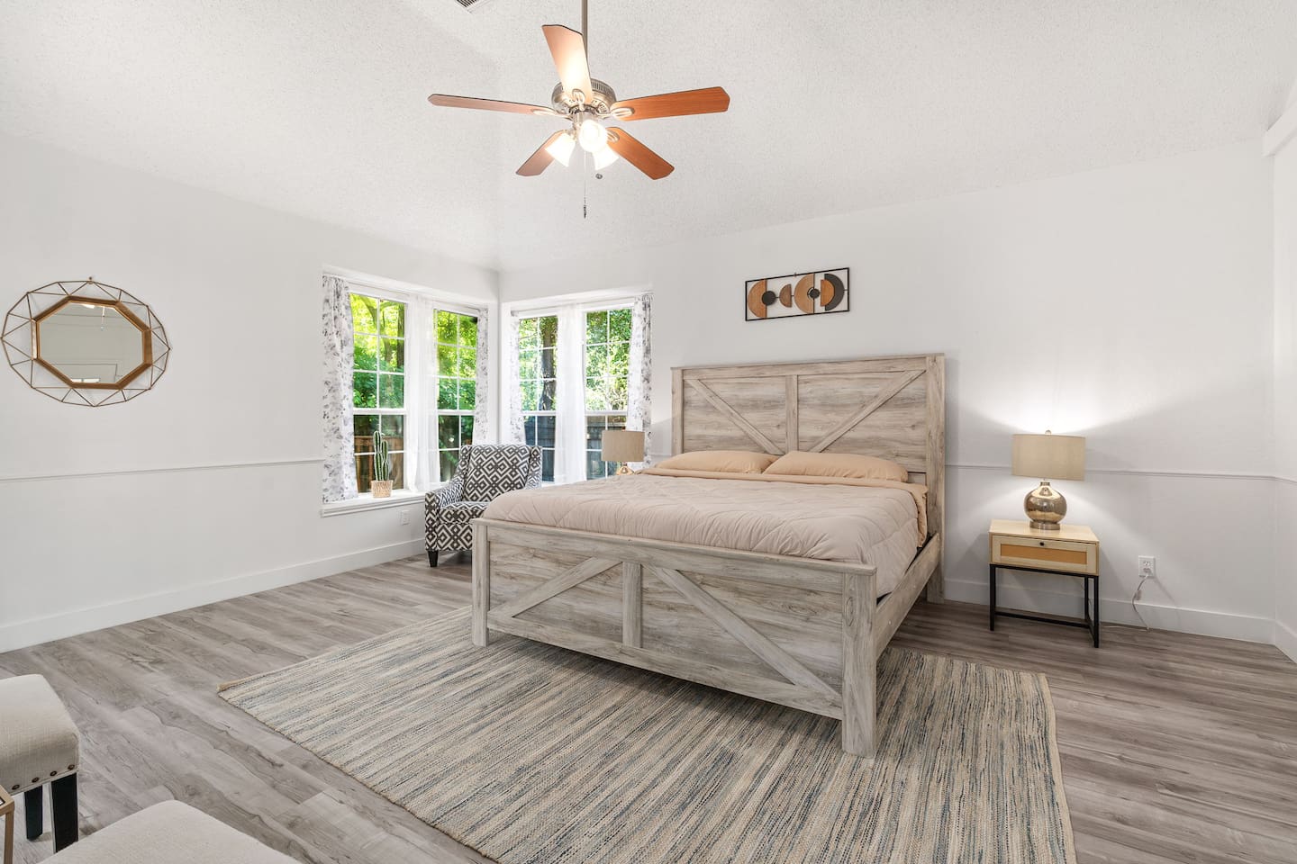 Chic bedroom with queen bed, room darkening shades, and warm light – designed for restful nights!