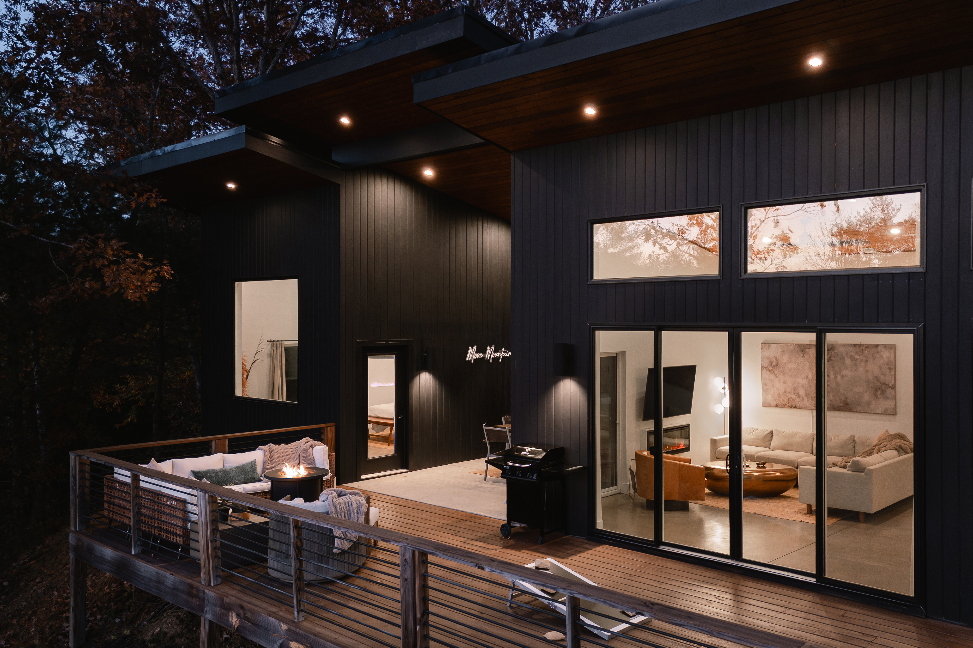 {Deck at Dusk - Glass House} Evenings glow here—soft light, cool breezes, and the warmth of the mountains reflected through the glass.
