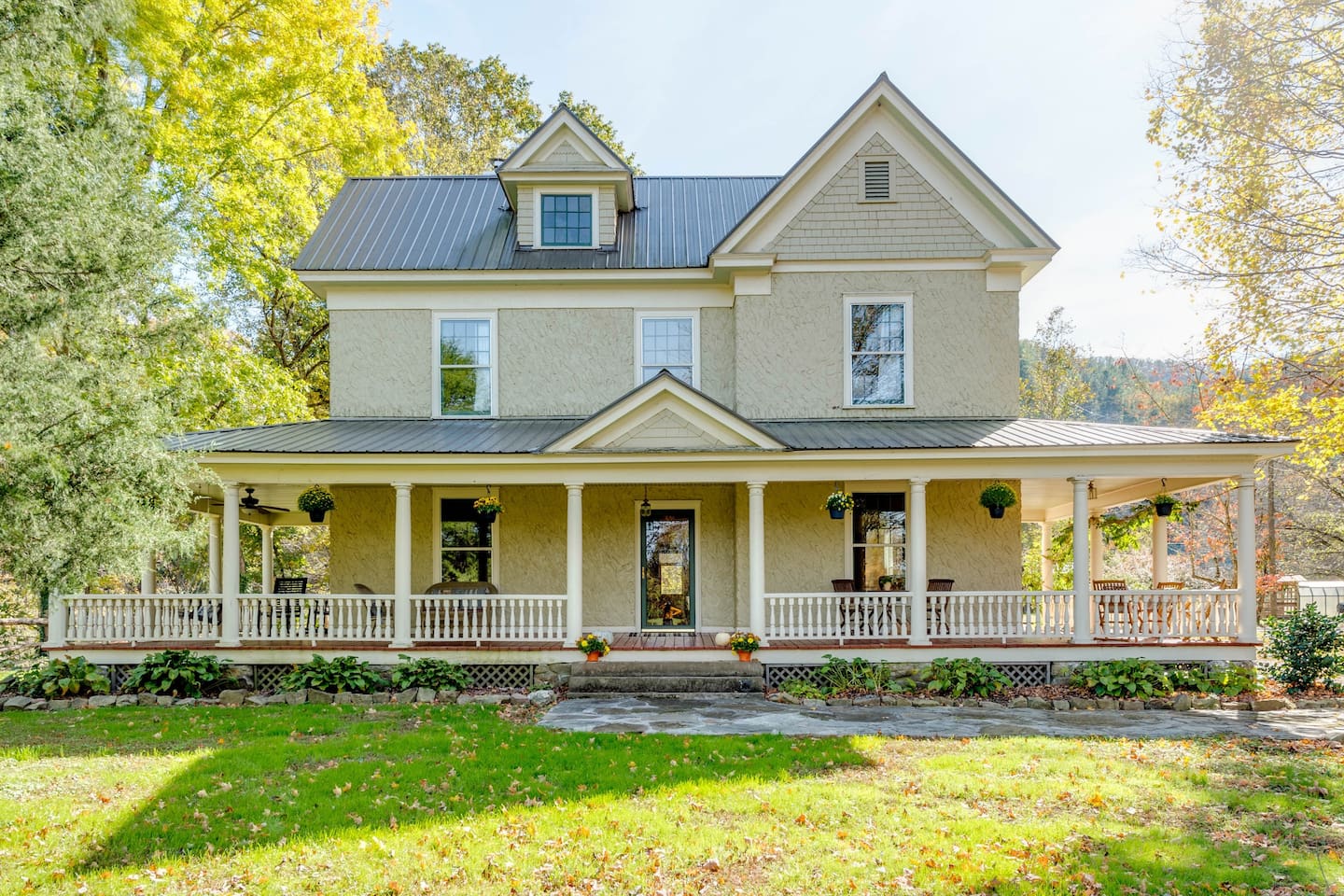 Traditional farmhouse wraparound porch provides a great place to sit and listen to Spring Creek below and watch the world go by.  