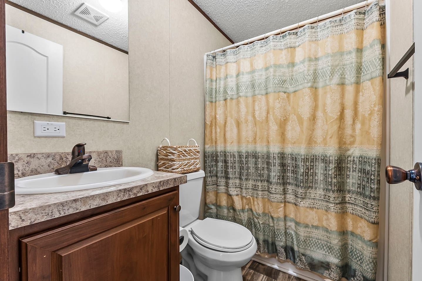 Full bathroom with shower and tub combo, spacious vanity, and clean, functional layout for a comfortable stay.