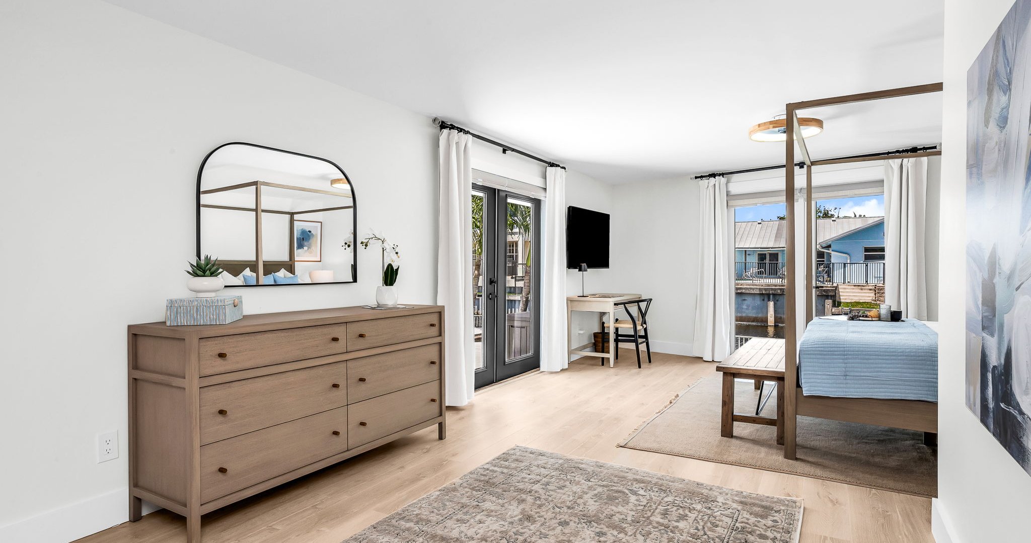 The primary king suite feels like your own private resort—featuring panoramic views of the pool and lake, seamless indoor-outdoor flow, and a newly renovated spa-inspired ensuite. Thoughtfully styled with designer finishes.