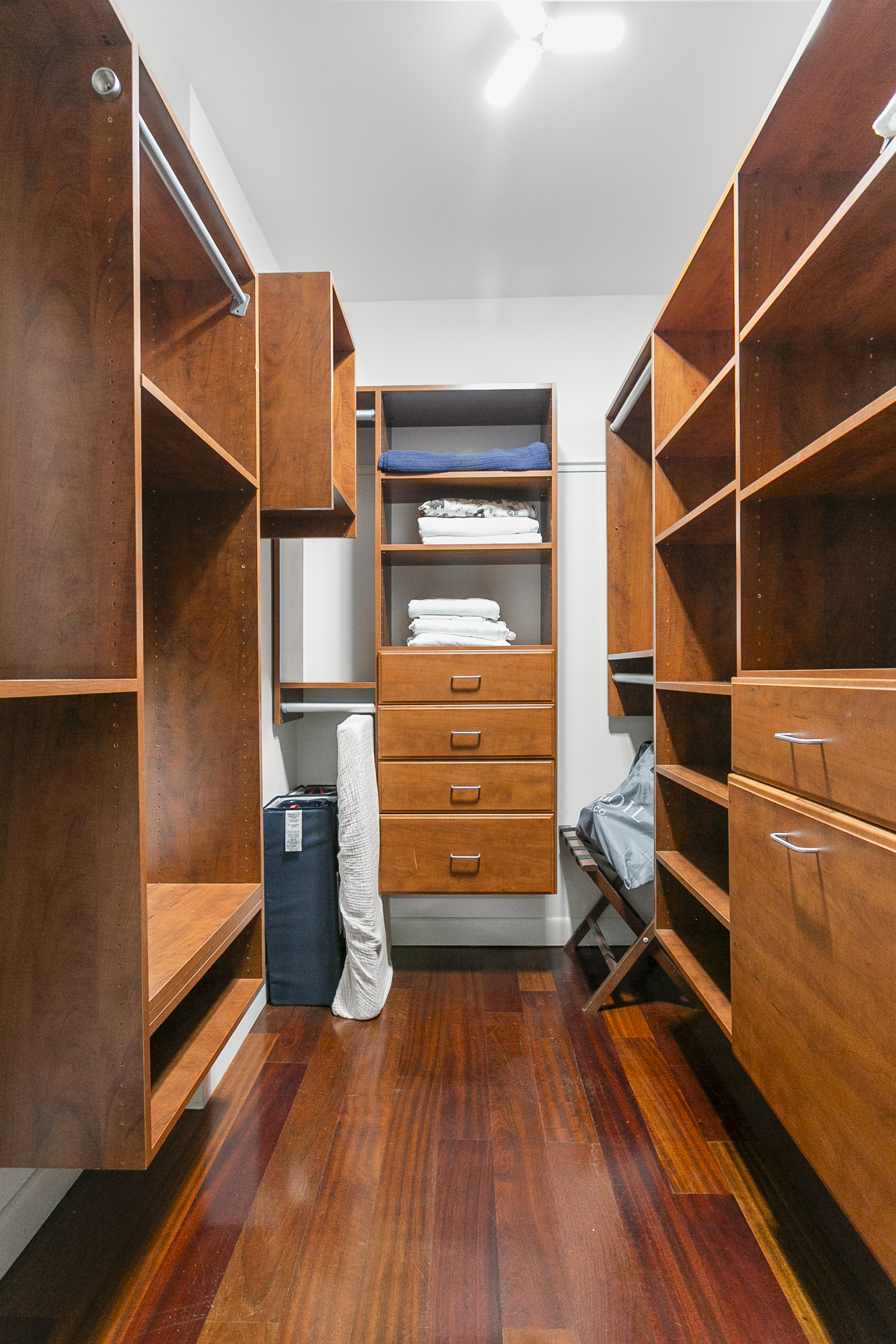 Walk in closet with ample storage, crib, air bed and extra linens.