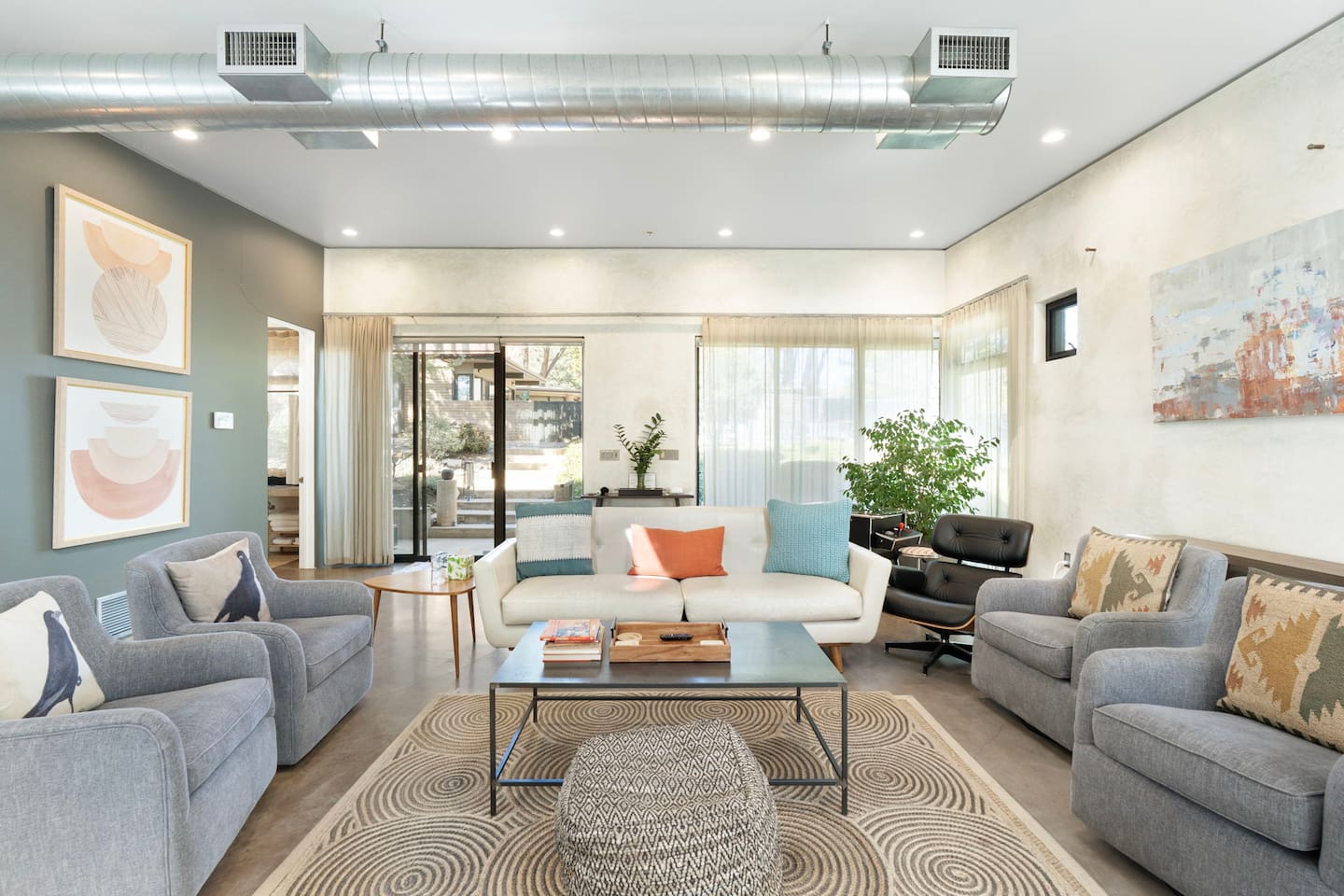 Stylish living area with modern seating, natural light, and a cozy layout — perfect for gathering and relaxing.