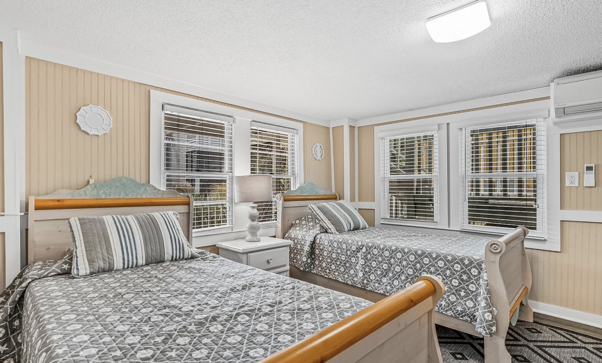 A bright, airy bedroom downstairs with soft, neutral bedding for easy rest. ⭐