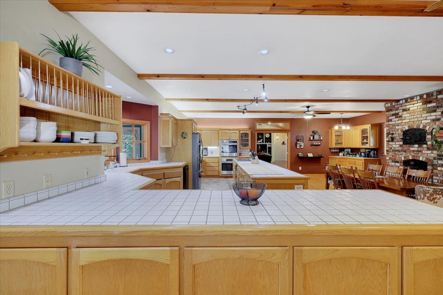 Spacious full kitchen with large gourmet island, wood cabinetry, stainless steel appliances, and plenty of prep space for group meals.