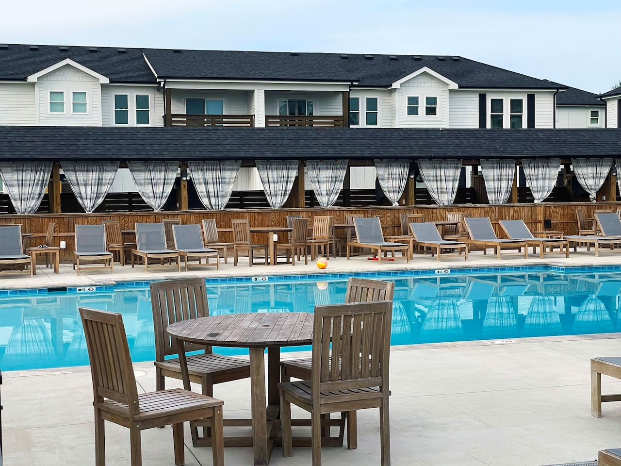 Take in the resort amenities with this expansive heated pool, surrounding sun loungers, and relaxing shared outdoor spaces.