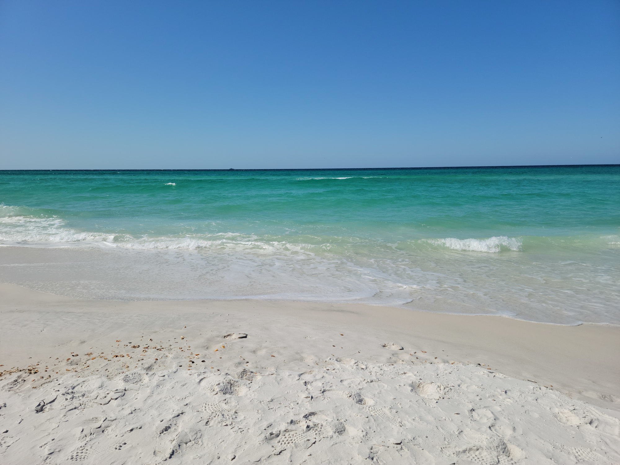 Feel your toes in the sand as you walk along the sugar white sand beach