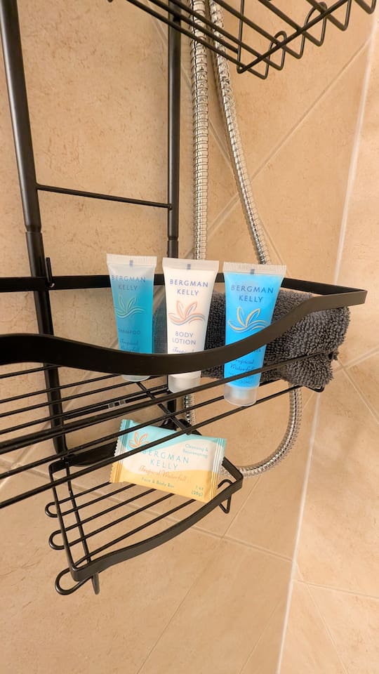 Bathroom features complimentary shampoo, conditioner, lotion, and bar soap in the shower. 
