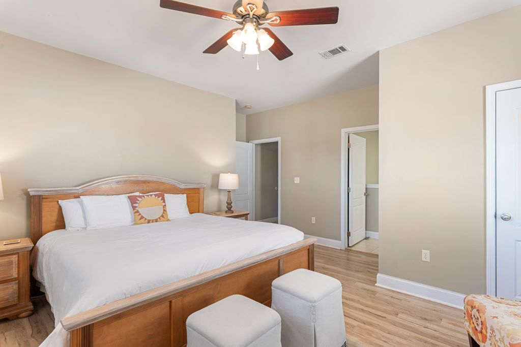 Second Floor: Bedroom 2 – Relaxing coastal-themed bedroom with nightstand, dresser, and TV for comfort.