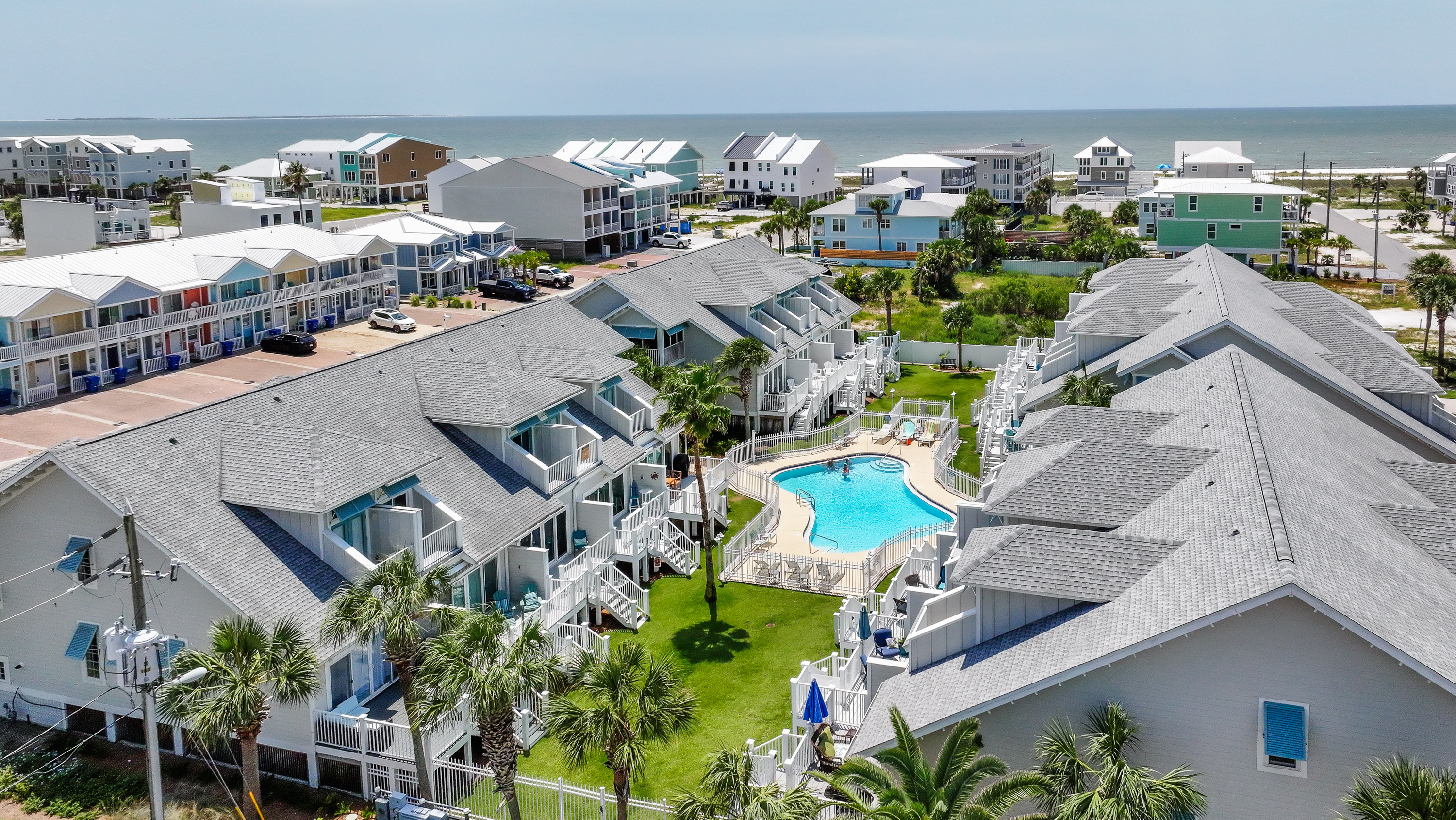 Aerial view of the coastal community featuring a sparkling resort-style pool